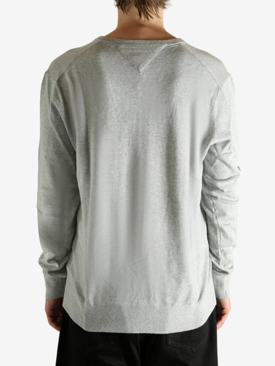 Grey sweater worn by a person, showing the sweater's fit