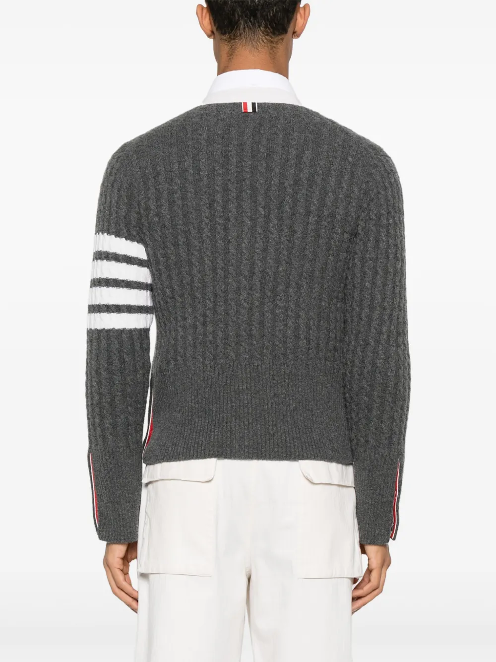 Grey knitwear worn by a person, showing the knitwear fit