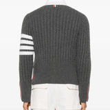 Grey knitwear worn by a person, showing the knitwear fit