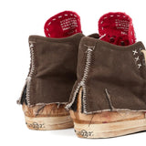 Close up of brown sneakers, showing texture of the cotton and rubber and goat leather fabric