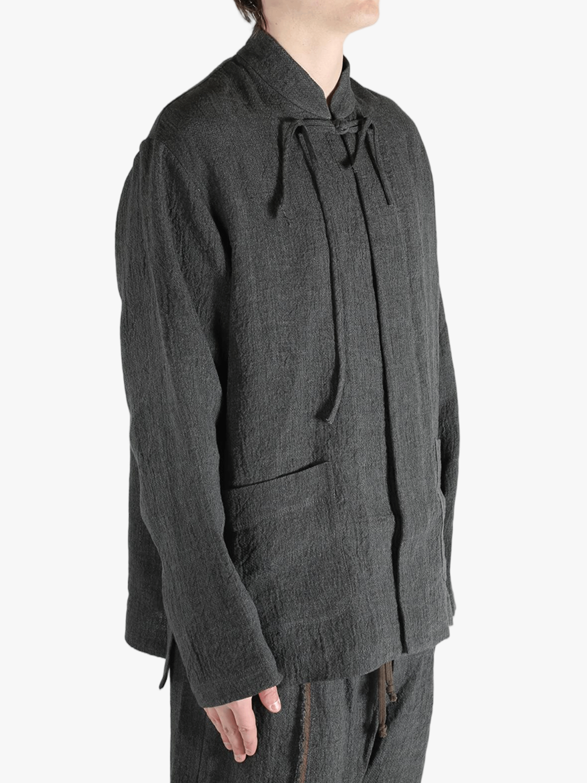 Grey jacket worn by a person, showing the jacket's fit