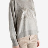 Grey knitwear worn by a person, showing the knitwear fit