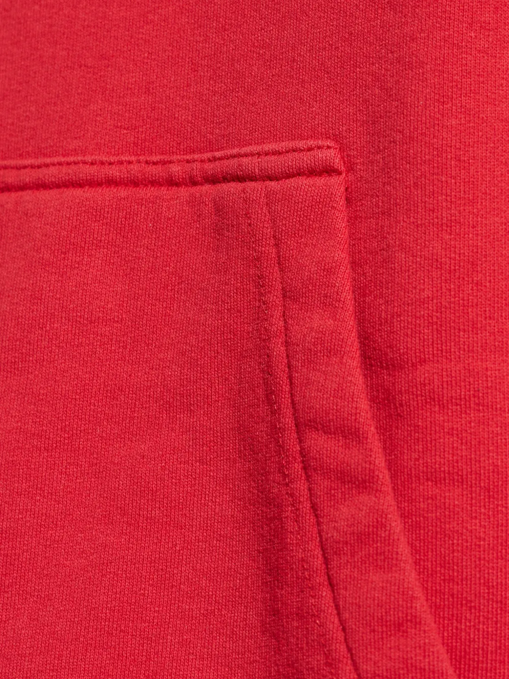 Close up of red sweats-hoodies, showing texture of the cotton fabric