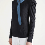 Black shirt worn by a person, showing the shirt fit