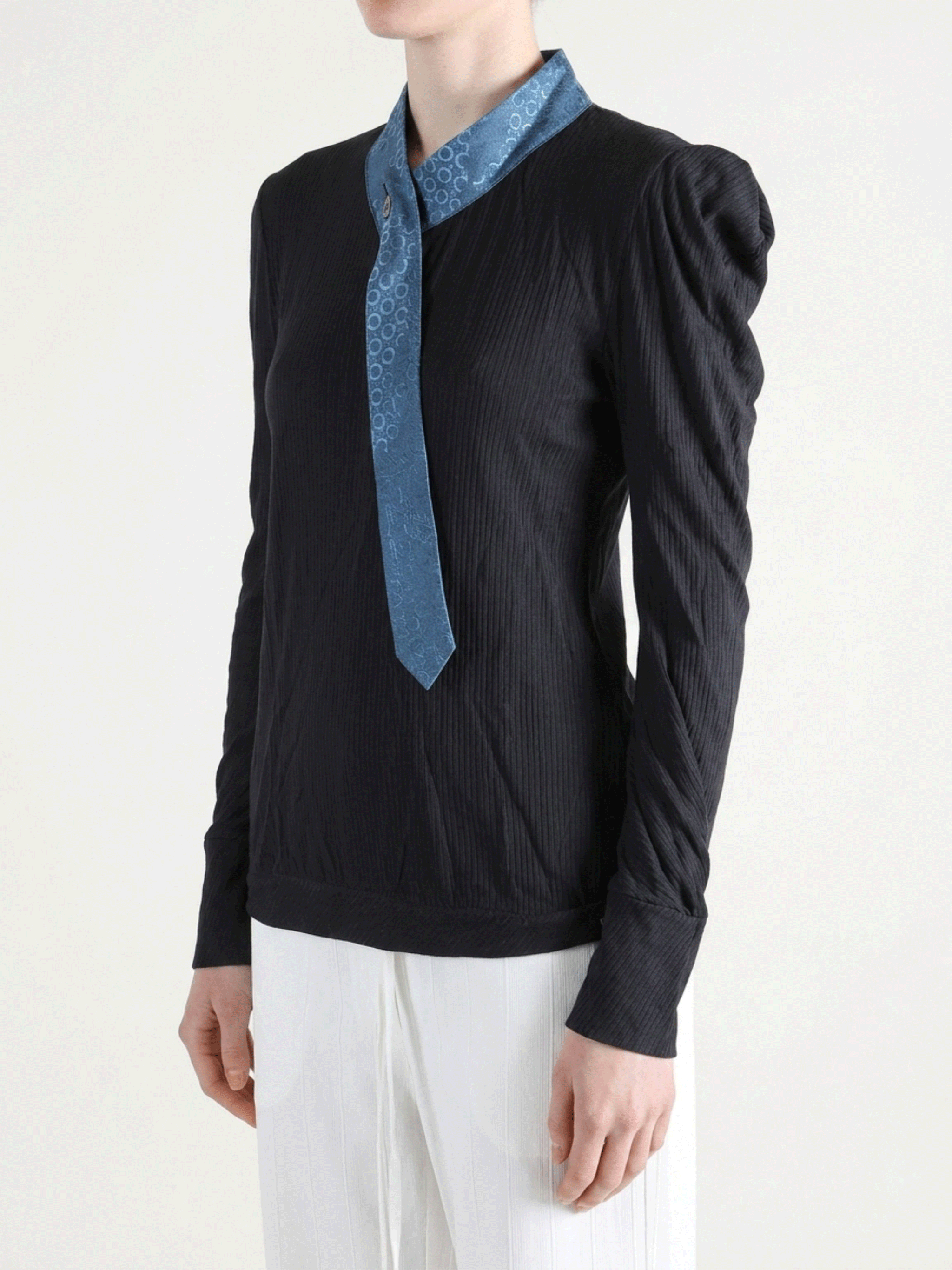 Black shirt worn by a person, showing the shirt fit