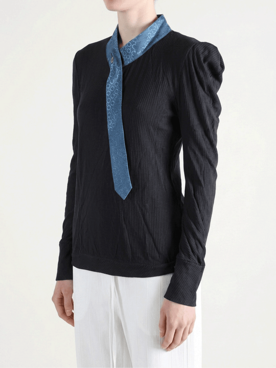 Black shirt worn by a person, showing the shirt fit
