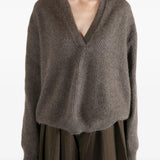 Brown top worn by a person, showing the top fit