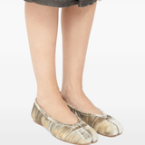 Tan shoes worn by a person, showing the shoes' fit