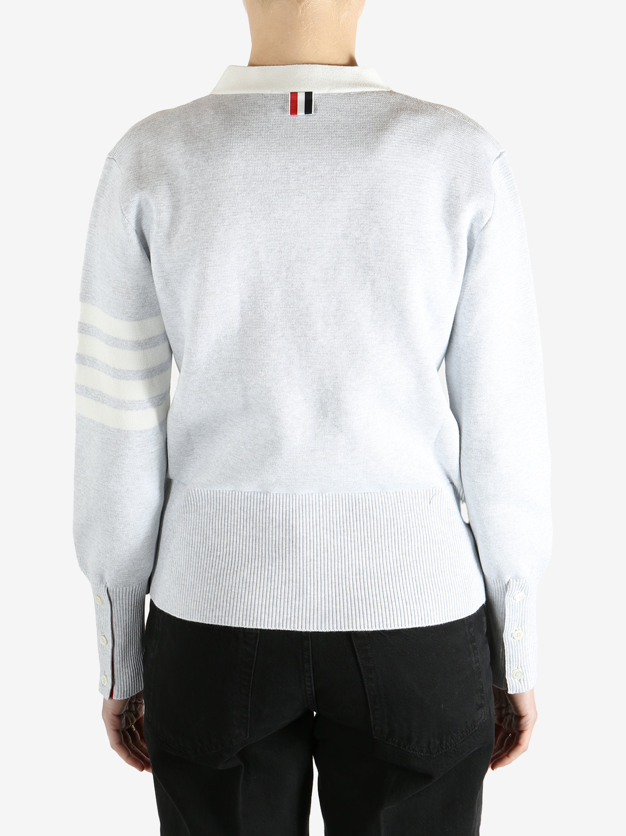 Gray cardigan worn by a person, showing the cardigan fit