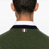 Close up of green knitwear, showing texture of the Wool fabric