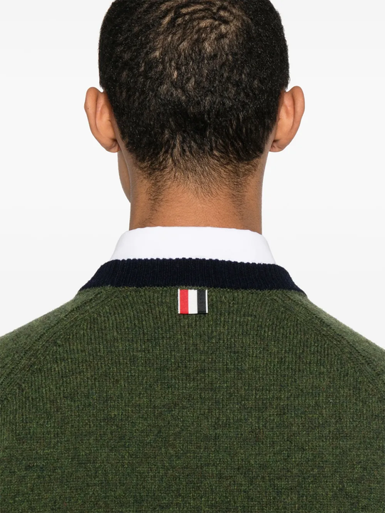 Close up of green knitwear, showing texture of the Wool fabric