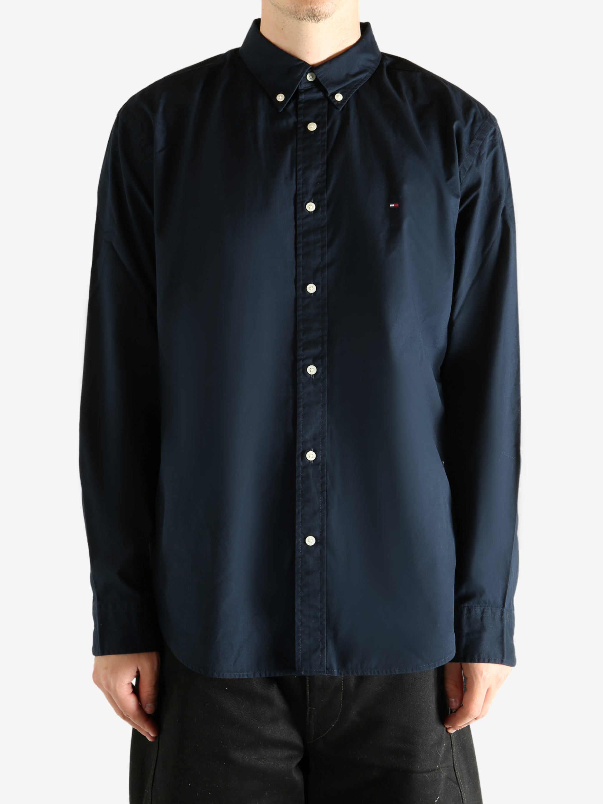 Navy shirt worn by a person, showing the shirt's fit