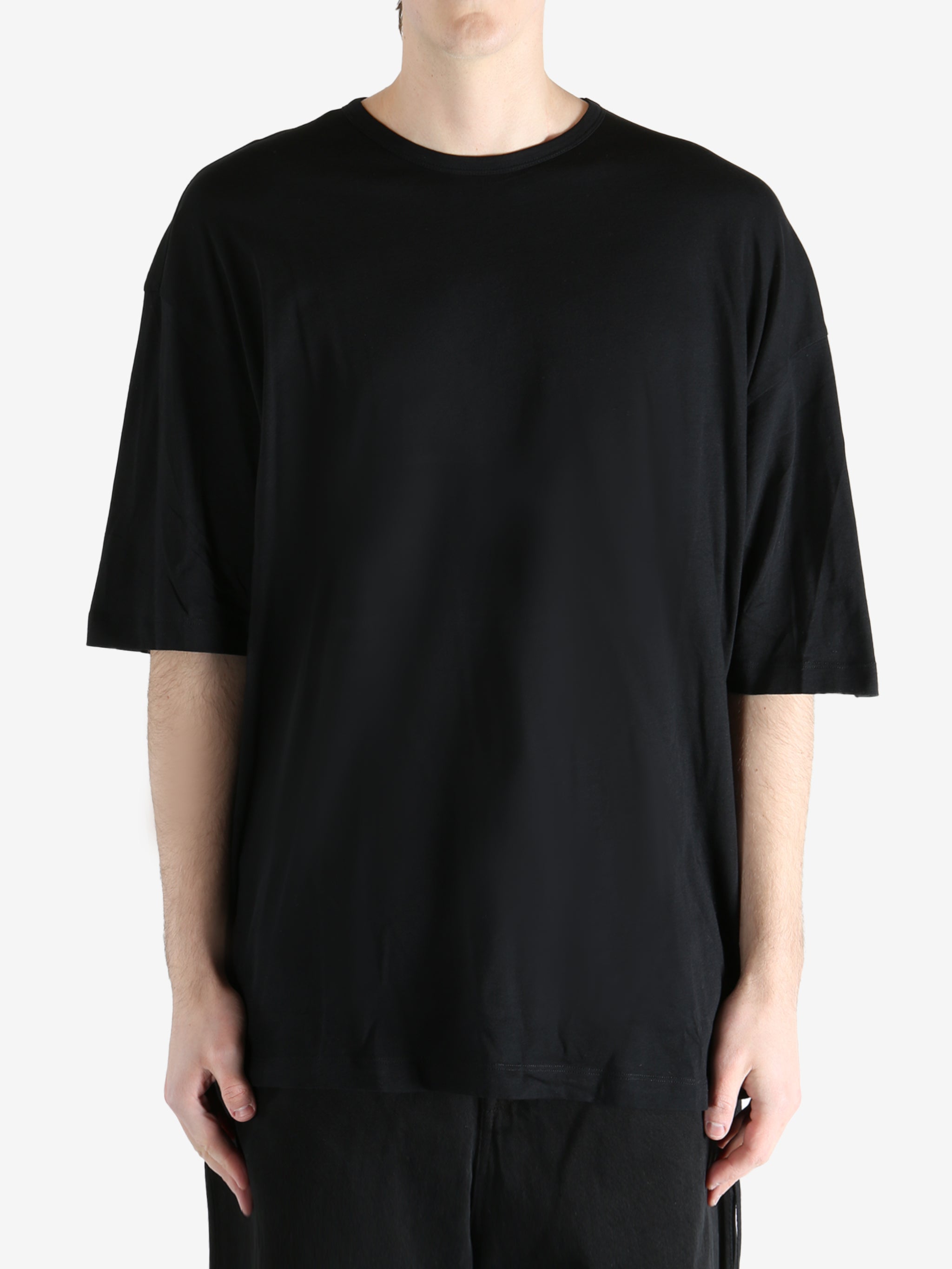 Black T-shirt worn by a person, showing the T-shirt fit