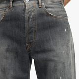 Black jeans worn by a person, showing the jeans fit