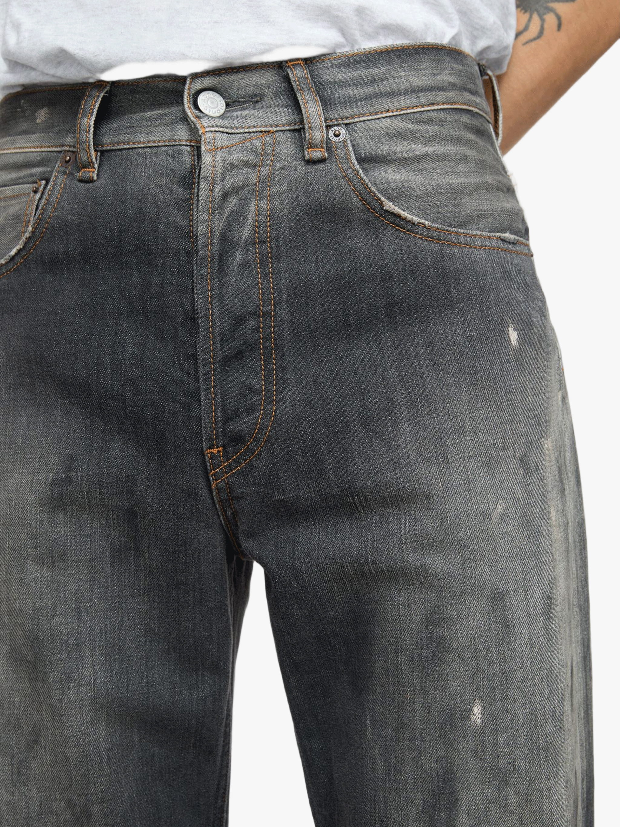 Black jeans worn by a person, showing the jeans fit