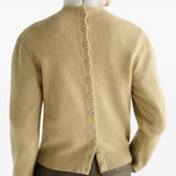 Tan hoodie worn by a person, showing the hoodie fit