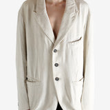 White blazer worn by a person, showing the blazer's fit