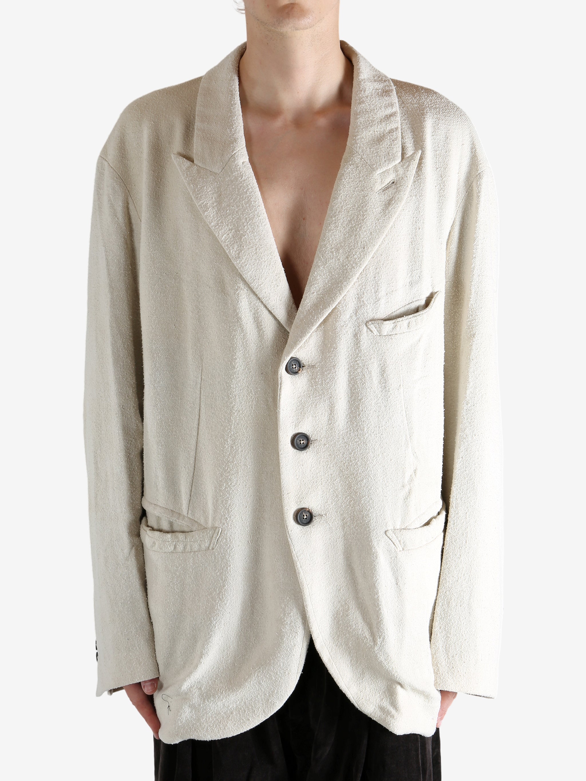 White blazer worn by a person, showing the blazer's fit