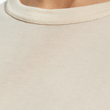 Close up of white t-shirts, showing texture of the cotton fabric