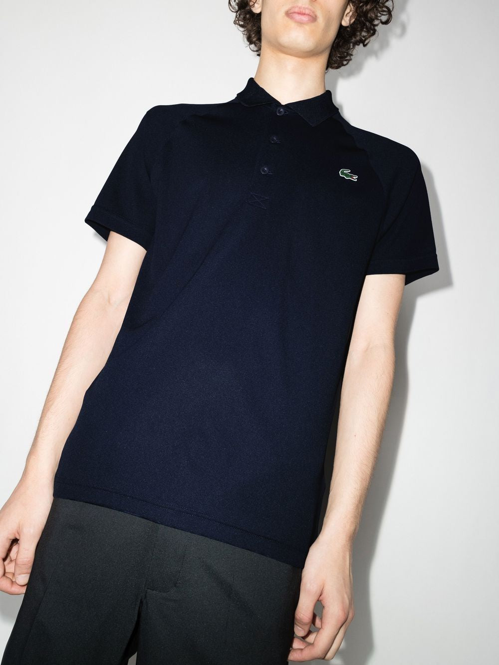 Navy shirts worn by a person, showing the shirts fit