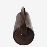 Close up of the brown bag, showing texture of the leather fabric