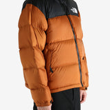 Orange jacket worn by a person, showing the jacket's fit