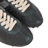 Close up of green sneakers, showing texture of the Polyester fabric