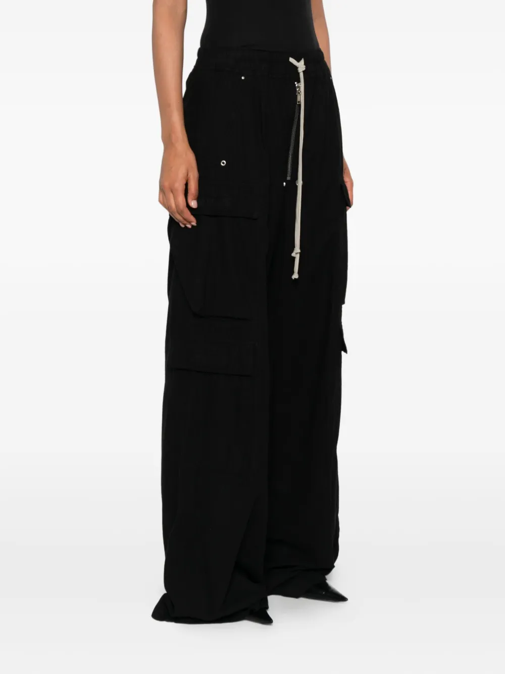 Black pants worn by a person, showing the pants' fit