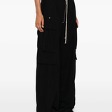 Black pants worn by a person, showing the pants' fit