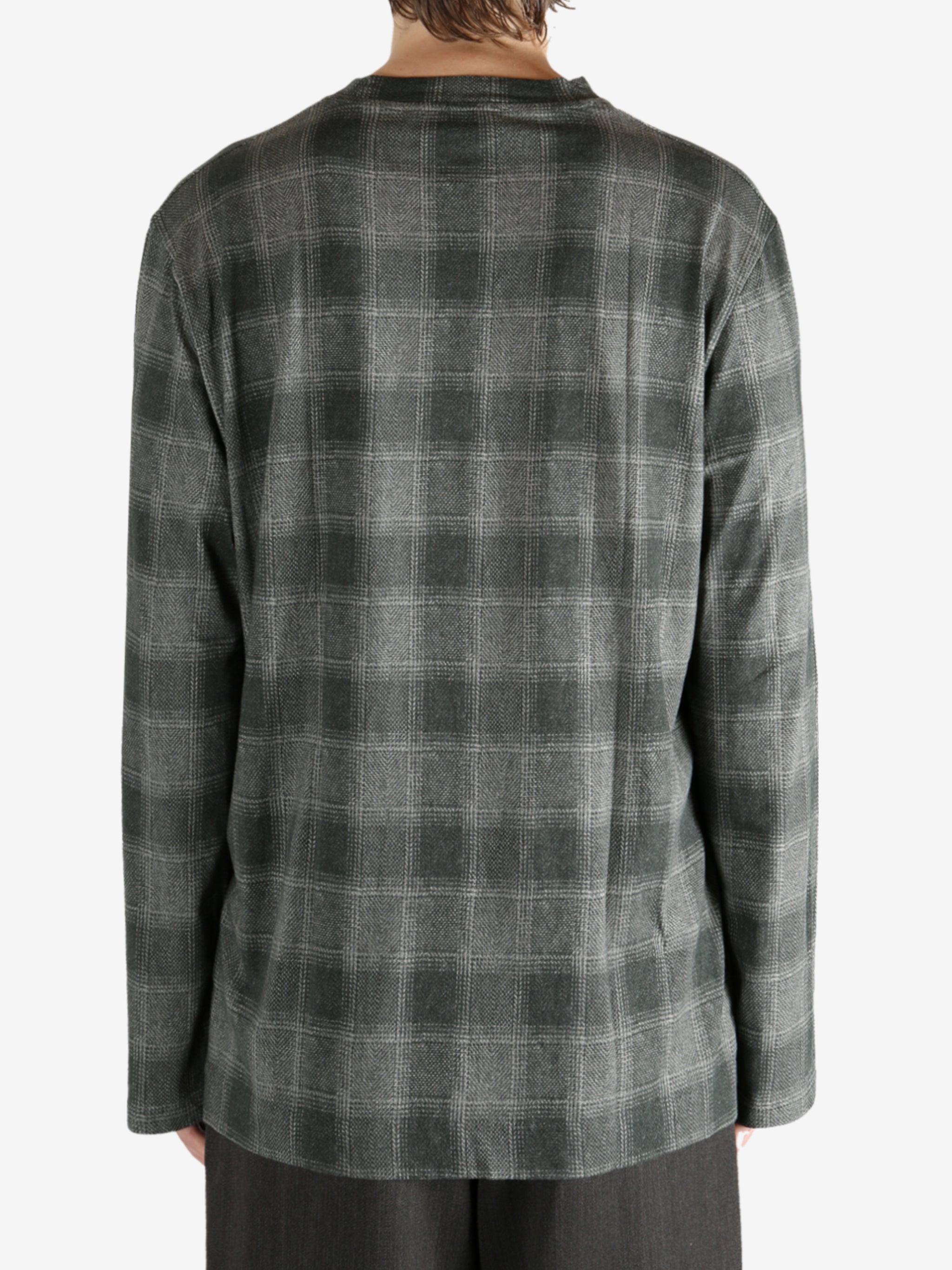 Grey shirt worn by a person, showing the shirt's fit