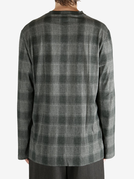 Grey shirt worn by a person, showing the shirt's fit