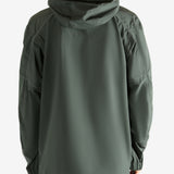 Green coat worn by a person, showing the coat fit