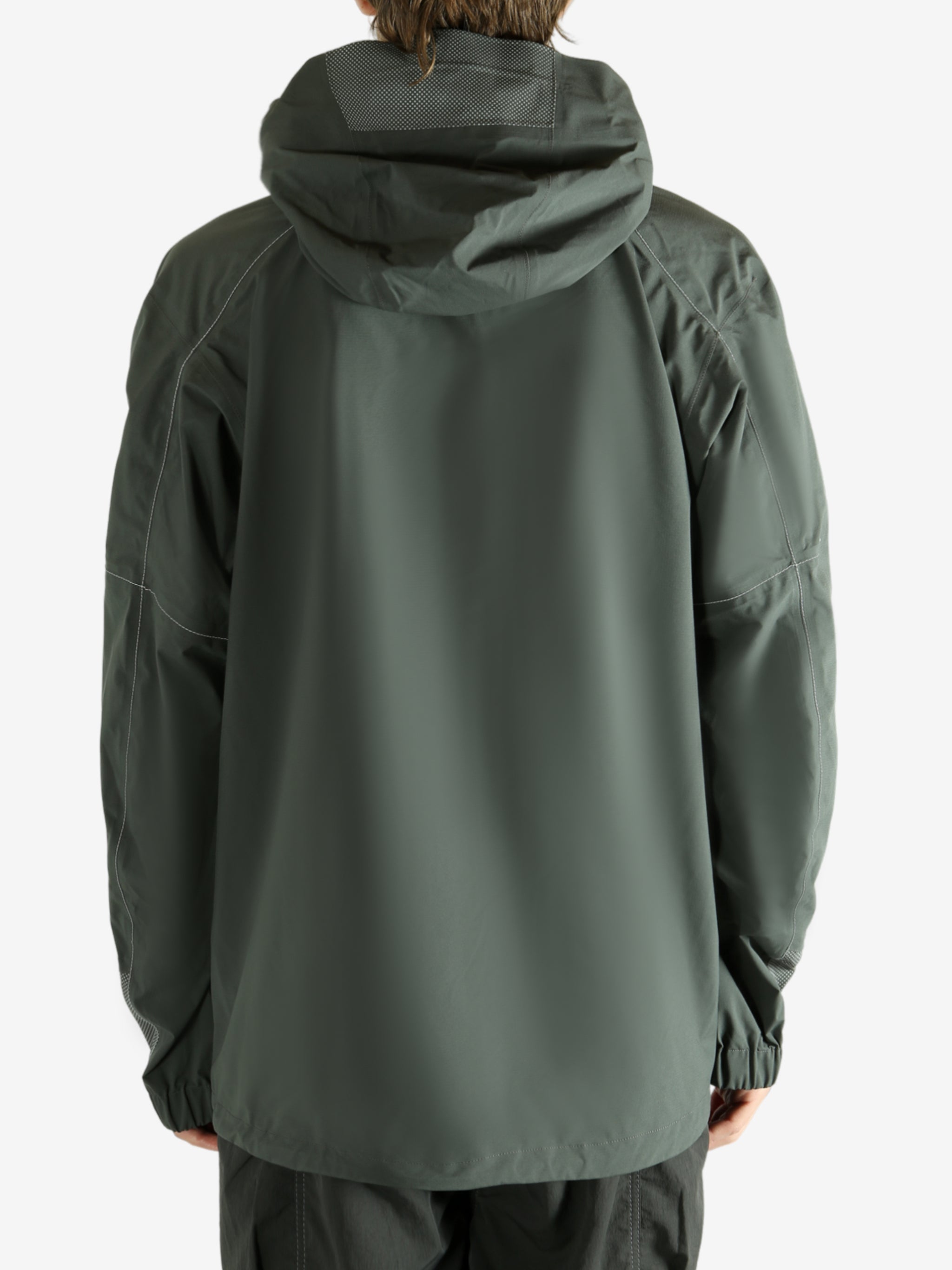 Green coat worn by a person, showing the coat fit