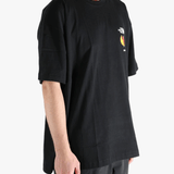 Black tee worn by a person, showing the tee fit