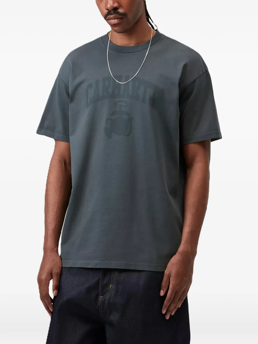 grey t-shirt worn by a person, showing the t-shirt fit