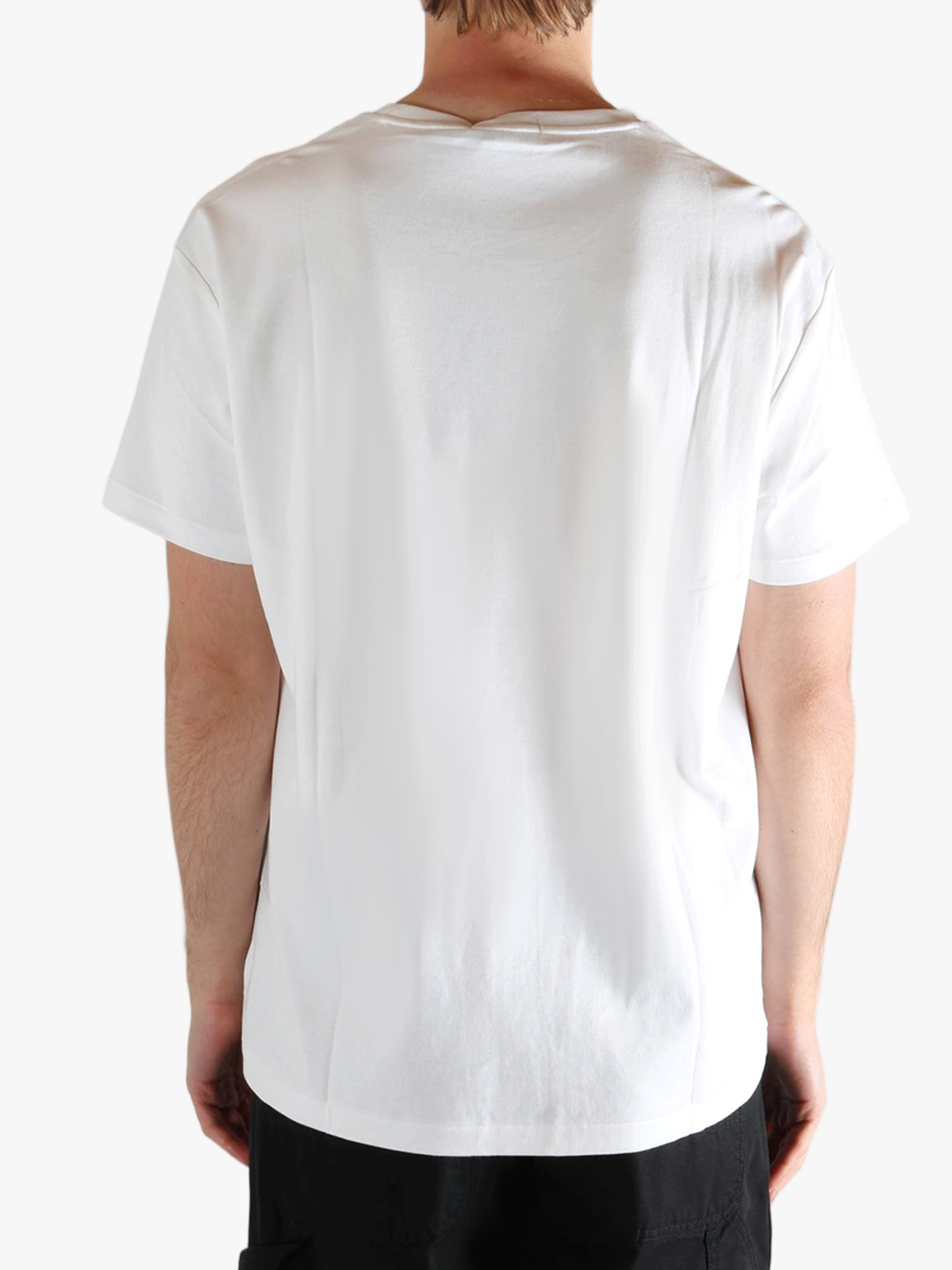 White t-shirts worn by a person, showing the t-shirts fit