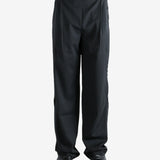 Black pants worn by a person, showing the pants' fit