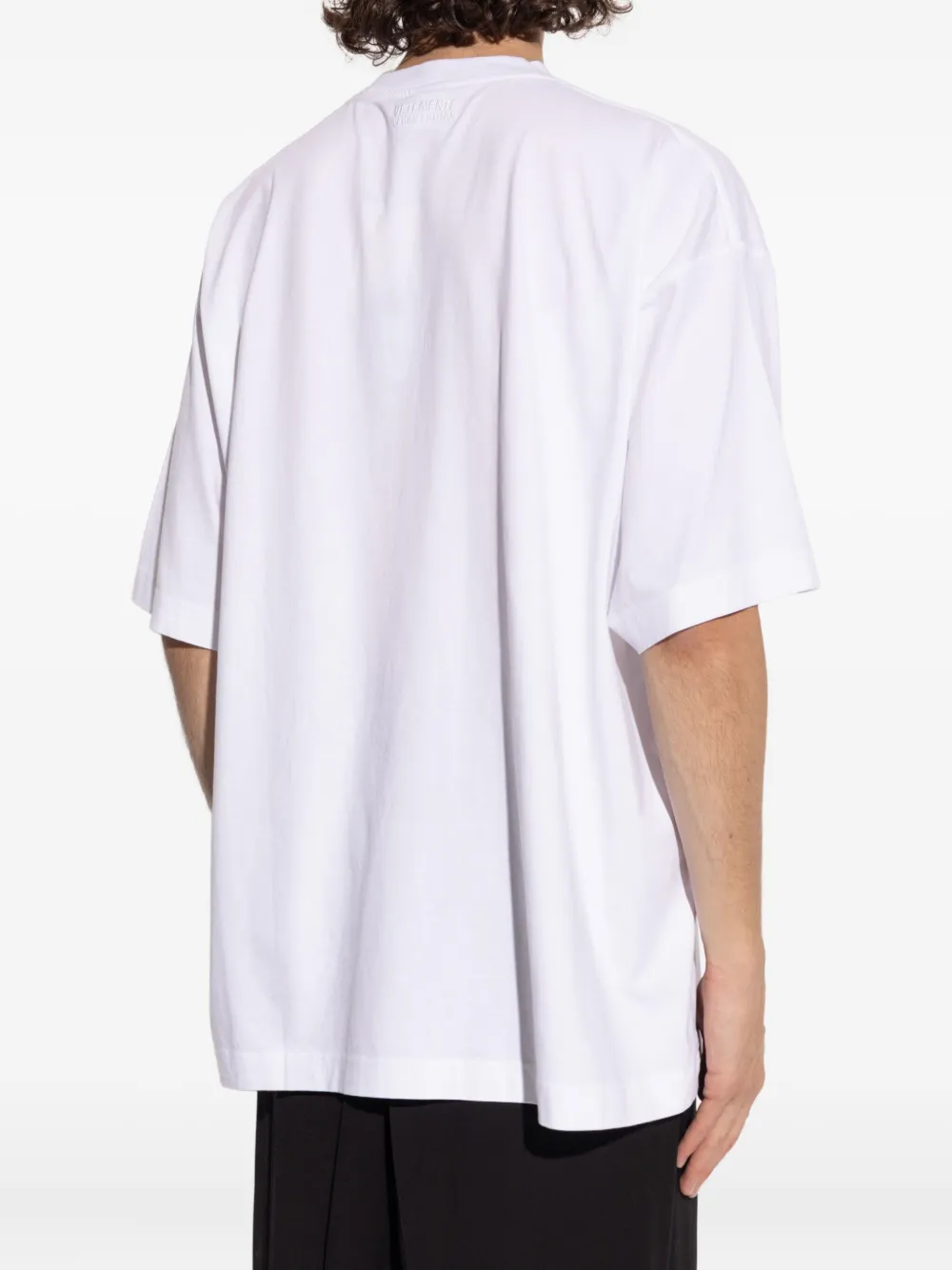 White t-shirt worn by a person, showing the shirt's fit