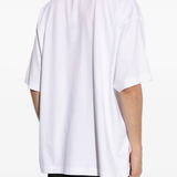 White t-shirt worn by a person, showing the shirt's fit