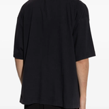 Black t-shirt worn by a person, showing the shirt's fit