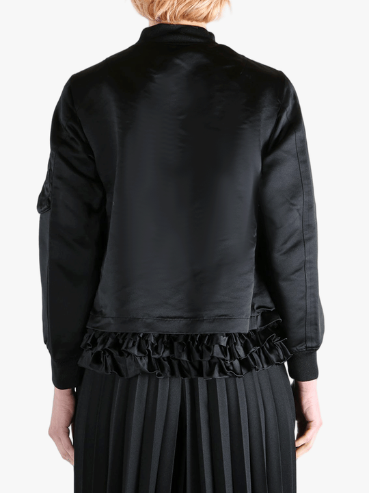 Black jacket worn by a person, showing the jacket's fit