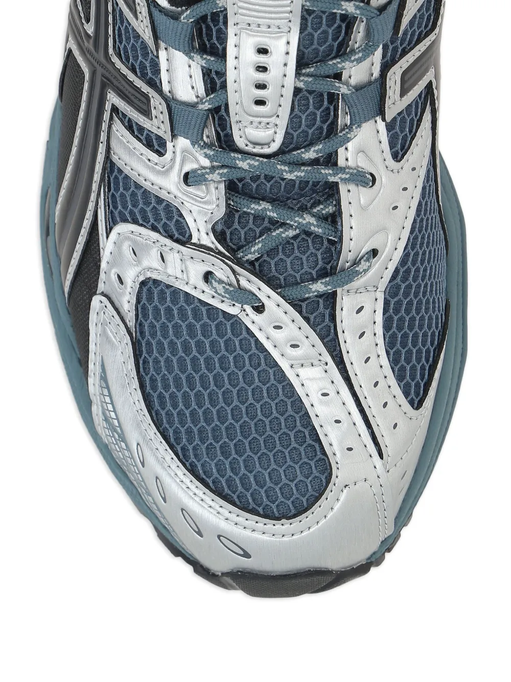 Close up of green sneakers, showing texture of the rubber fabric