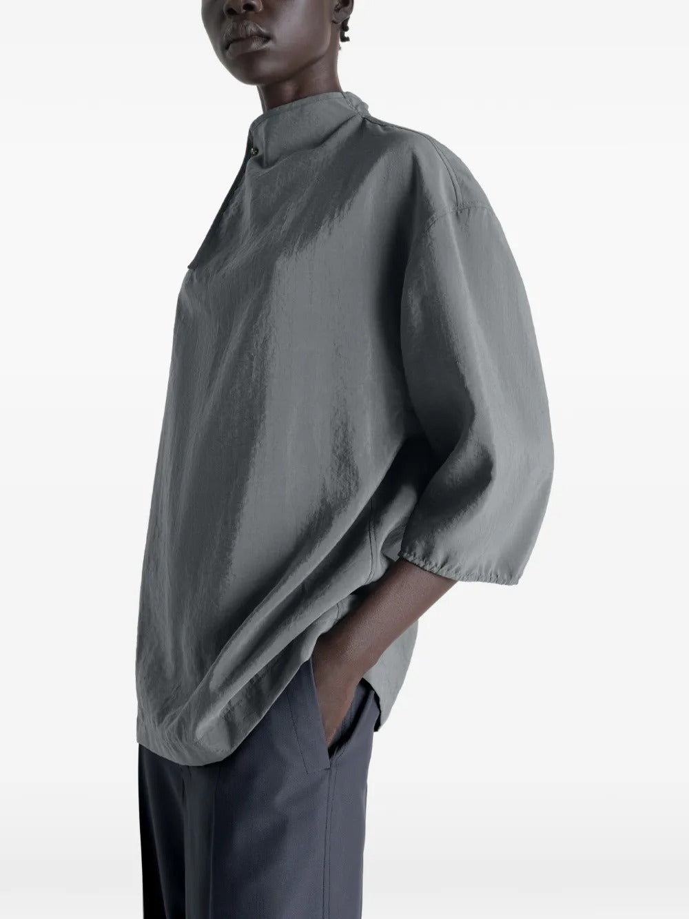 Grey top worn by a person, showing the top's fit