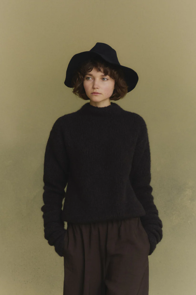 Navy knitwear worn by a person, showing the knitwear's fit