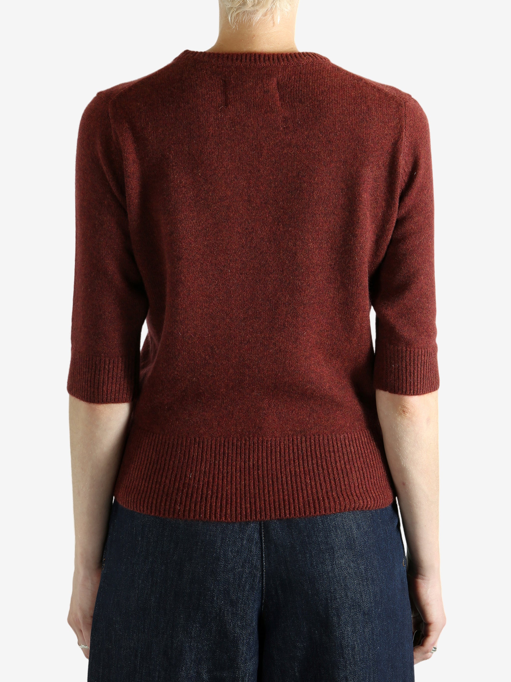 Red sweater worn by a person,showing the red sweater‘s fit
