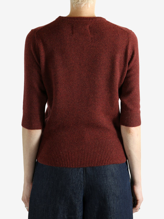 Red sweater worn by a person,showing the red sweater‘s fit