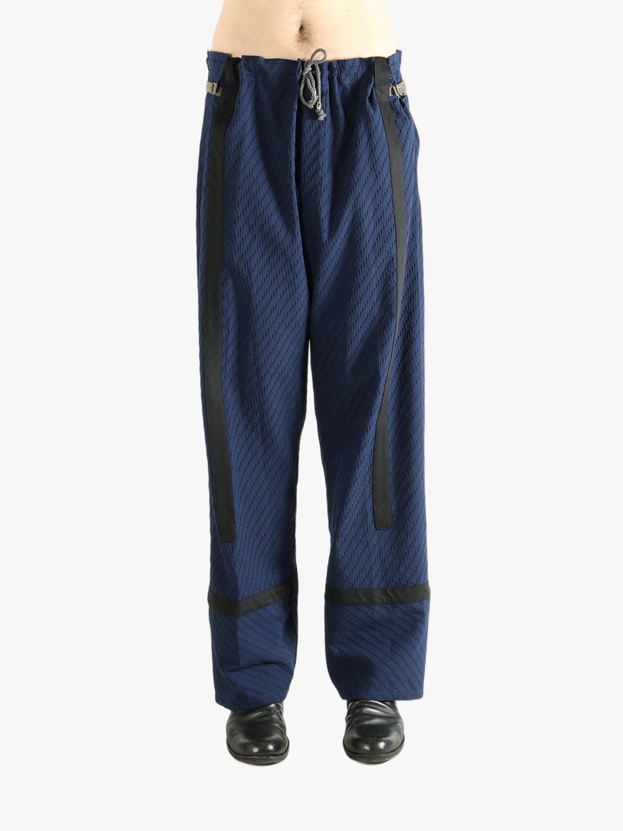 Blue pants worn by a person, showing the pants' fit