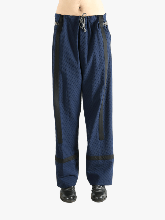 Blue pants worn by a person, showing the pants' fit
