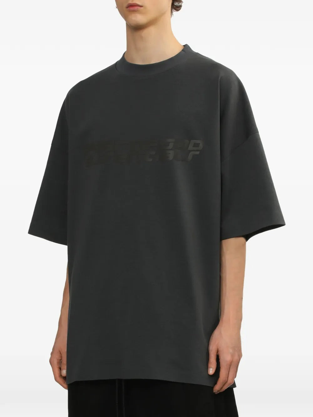 Grey t-shirt worn by a person, showing the shirt's fit