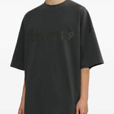 Grey t-shirt worn by a person, showing the shirt's fit